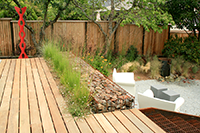 Ipe decking, rock, and steel are simple materials yet accentuate the pop of color of the sculpture.