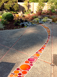 Recycled glass disks create movement and to lead the eye through the patio space.