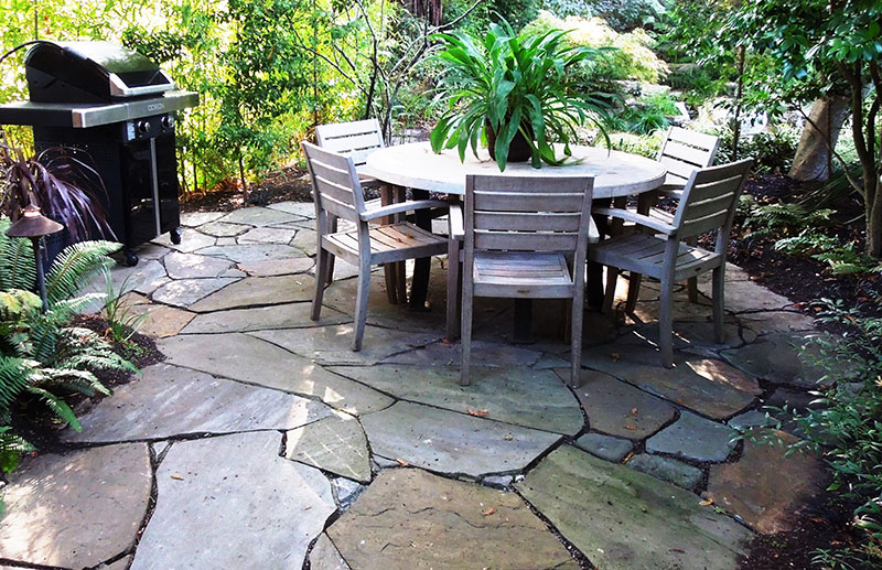 Patio created from large pieces of random-cut flagstone set in sand is stable, yet welcoming.