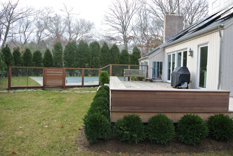 backyard landscape design, deck with surround shrubs and pool in back